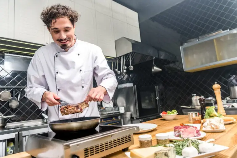 smiling-chef-frying-meat-in-restaurant-kitchen-2023-11-27-05-26-53-utc-768x513